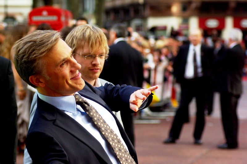Actor Christoph Waltz has arrived, and it looks strangely like he's wearing an oversized mask... of his own face. He plays Captain Hans Lander in the film.