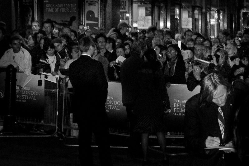 (Foreground, right) Actor Viggo Mortensen (Lord of the Rings, A History of Violence) diligently signs autographs for fans at the gala screening. Another difference between a premiere and a gala screening is that the Red Carpet is narrower, can wind around the outside of a building while cars park behind the cinema, and stars go in one side of the cinema entrance while 'normos' can go in via another one.