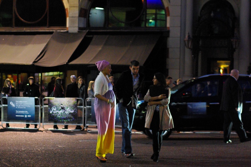 People have arrived. And the are.... wearing bright clothing. A small, but appreciative, crowd, bears witness.
