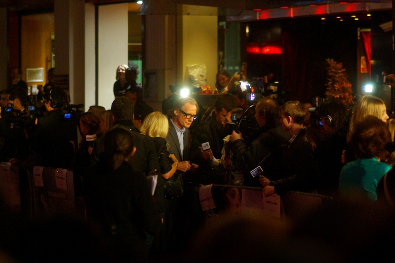 Actor Bill Nighy has been in nearly every movie ever made, and been at the premiere for many of the rest. In this instance.... he's both in the movie and at the premiere. Well played, sir!