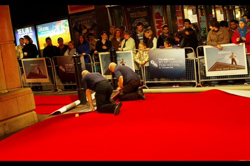 A kinked Red Carpet means this is a smaller premiere. (From brutal experience, this typically means Charlize Theron will not attend, and even Yellow Cap Guy is only a 'maybe'). This movie was for a Coen Brothers film, so perhaps one or both would deign to attend. And John Hurt would probably show up regardless.