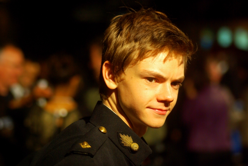 This is (I believe) Thomas Sangster. If so, he plays Paul McCartney in this movie. The pseudo-military jacket design may not be thematically accurate, but it is kind of cool.