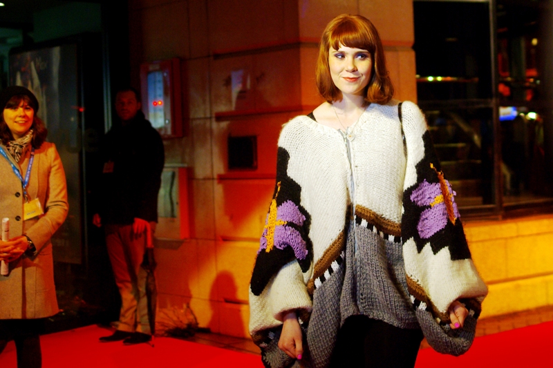 No idea who... but surely you can't argue with the needlecraft in the knitting? (Edited to add : She's Kate Nash) (supplementary editing to add : Who is Kate Nash?)