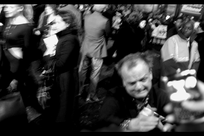This may possibly be actor Toby Jones in the foreground and the crowd swirls around and I absently wonder whether I might have been better off using a flash for this photo. (He provides the voice of the character Dobby the House Elf in whichever Harry Potter films that character appeared. The second..?)