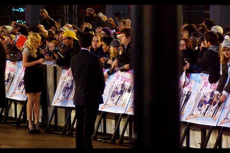 Yellow Cap Guy shoots! Yellow Cap Guy Scores! Not only does nobody really, truly know who Clara Paget is, but he’s now got her autograph and made what I hope is a connection. Well done!