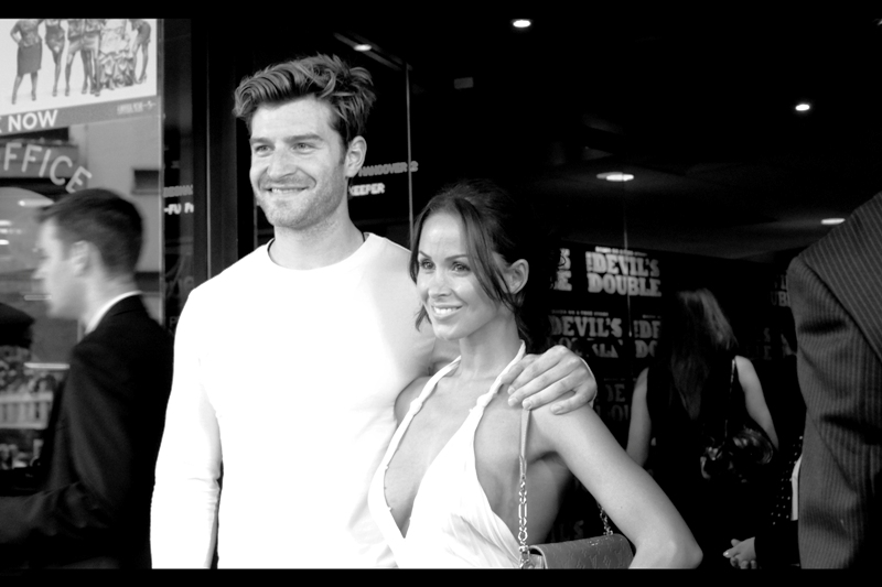 A man and a woman united by the love of crisp white reflective clothing. (But who is famous and who is not? Or is that unimportant next to how stunningly their clothing merges together when photographed in high-key black'n'white?)