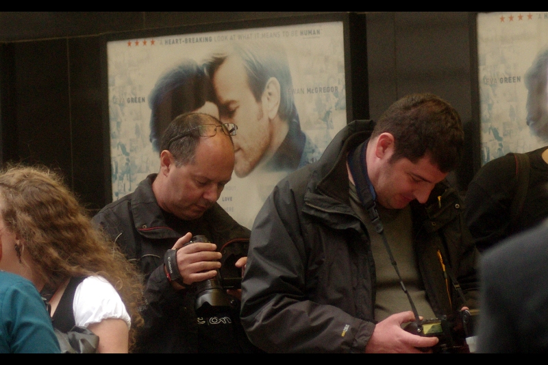 Man on Left: "Oh, yes. That photo turned out nicely... it radiates warmth as if I'm being nuzzled lovingly by... HEY! Stop framing me like that!"
