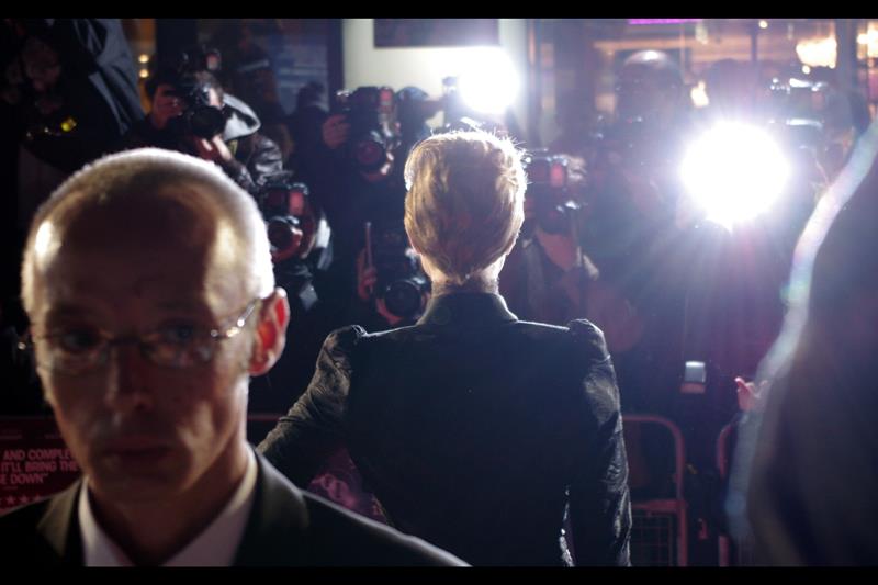 Evan Rachel Wood does not turn around when posing for the Paparazzi (not even to do that 'over the shoulder' look they're always asking for). Still... it got the security guard looking camera-wards. He was pretty cool - even kept an unbidden eye on my bag when I switched locations later in the premiere... (like I said, tragically, my trouble is with The Ladiez) (perhaps I need to stop calling them that?)