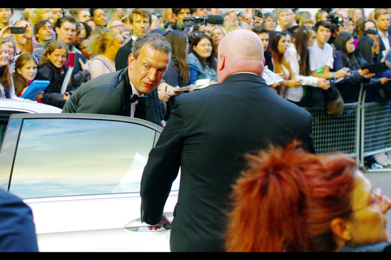 I ... don't know who this is. But I feel like starting a friendship with the neck-fatted security guy, as he (and/or the back of his aforementioned neck) will be showing up quite a lot at this premiere)