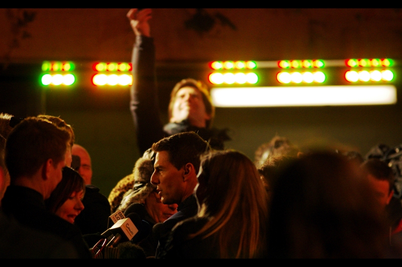 This is not so much a photo of Tom Cruise as it is of the dude in the background valiantly attempting to do the greatest leap in history to get The Shot Of Tom Cruise on a mobile phone.