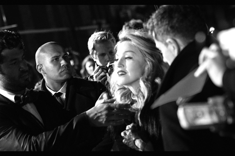 Madonna's handlers pursued a strategy of 'yo-yo-ing' her back and forth from the media area to the crowd to alternate between being interviewed and signing autographs. And then, sporadically, her hair would be brushed on the carpet. Intriguing