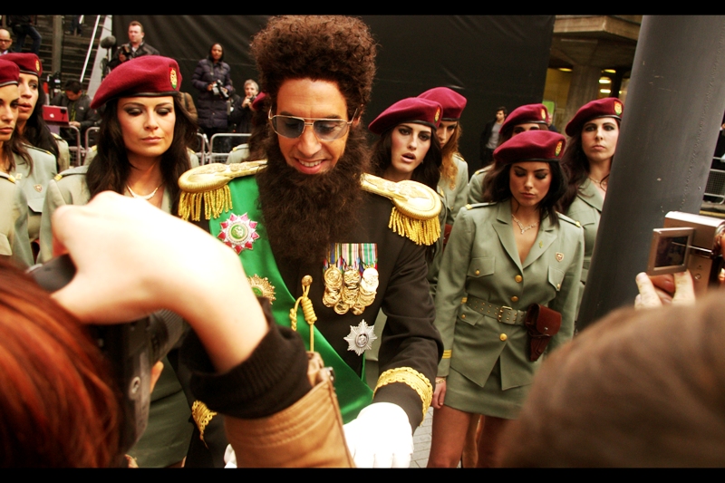 The General signs autographs, fatwas and decrees that are unlikely to be recognised by the United Nations for adoring fans. Meanwhile, I may possibly continue to be distracted by the incredible pout of the lamborghini-accompanying security lady on his left.