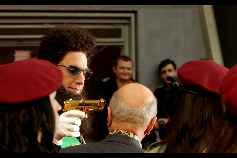 Aladeen pulls a golden gun on (former?) Harrods owner Mohamed Al-Fayed. Al-Fayed seemed to mind only a little. Still... nice to see the General is willing to get his hands dirty in front of the media in a foreign country. He did claim to be friends with Rupert Murdoch...