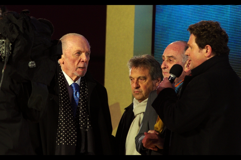 If these are the original guys behind the musical, I'm going with composer Claude-Michel Schönberg at left, directed by Robert Hossein in the middle, and 'libretto written by' Alain Boublil on the right. Either that or three ordinary cinema patrons are answering some pretty detailed questions with AMAZING aplomb.