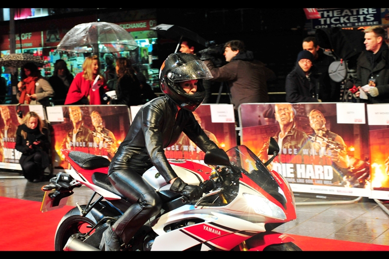 About two half hours later, I have my spot, things are set up, the rocknroll music is pumping and it looks like (a) it's about to start (b) to rain. And, no, the connection between the fifth Die Hard film and women on motorbikes dressed in leather/pvc has not yet been established. But I say go with it until proven otherwise.