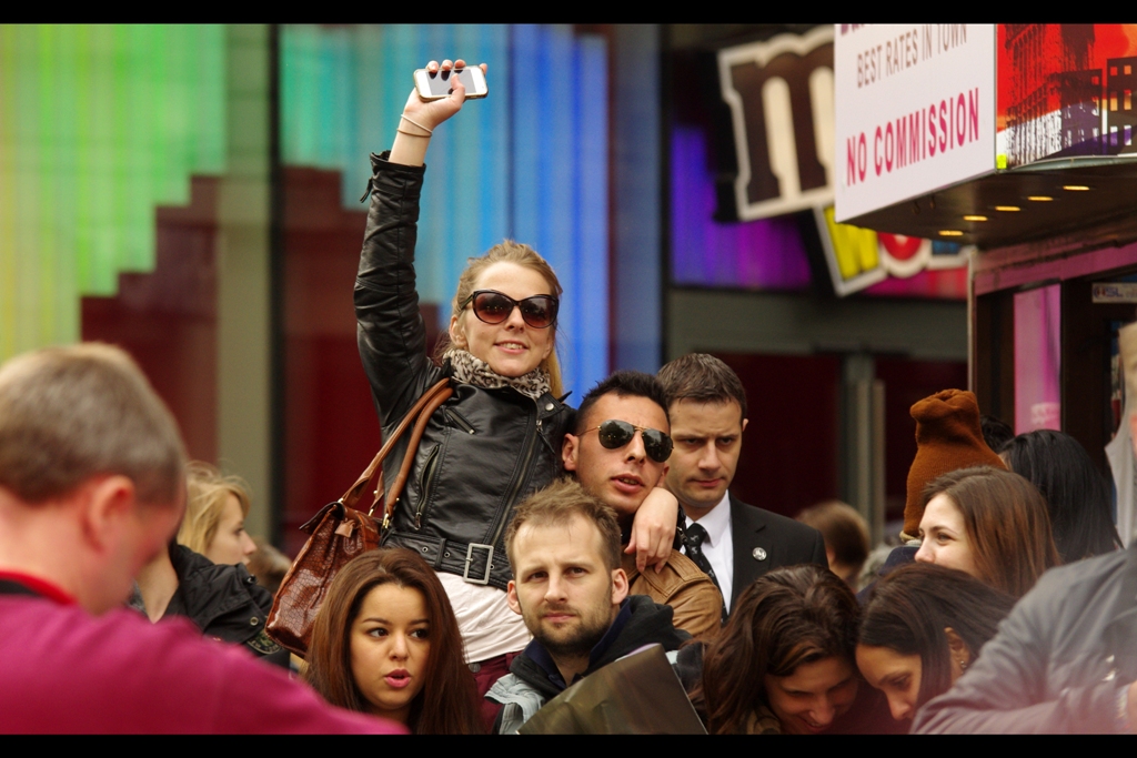 The boyfriend holding her up has not yet realised that there is no way that allowing your girlfriend to see Bradley Cooper with her own eyes is going to end well for you. (Or so I theorise).