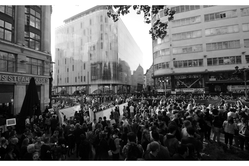 I decide to at least keep moving. This is possibly my favourite 'compromise' shot - a shot I can't ordinarily take because I'm too close to the action. This shows some of the layout of the premiere - not just the fans, but also the huge multi-storey press stage, cars dropping off celebs, and also the queue of invited guests and ticket holders and their separate queue to walk the red carpet. I actually quite like the full-size image " which is here in case you are interested "