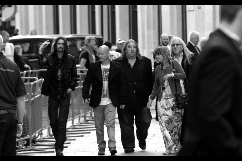 It's ON! Or rather, it appeared at the time to Be On - two days after the premiere and still Wireimage and Getty Images have not identified who the gentlemen on the left, second from left and far right with the silver hair are, EVEN though they posed and EVEN though they got interviewed and EVEN though they signed autographs. I'll let you know if/when I find out. Placeholder ID theory : they're a concert metal/classical hybrid Chopin tribute band.