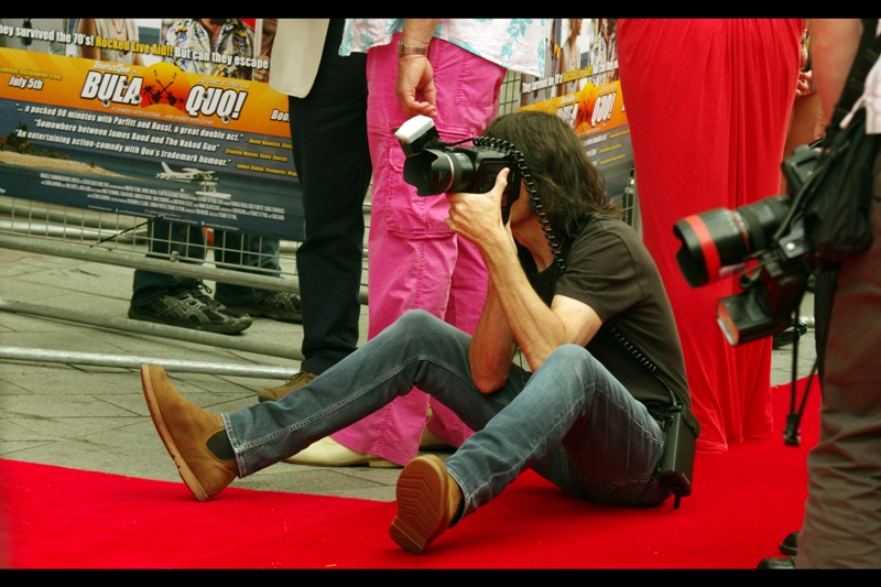 I'd ordinarily take photos of red carpet photographers only so I can laugh at them as a way to distract from my deep-rooted jealousy over their access to events. But there's a secondary reason. (And it isn't the shoes he's wearing).