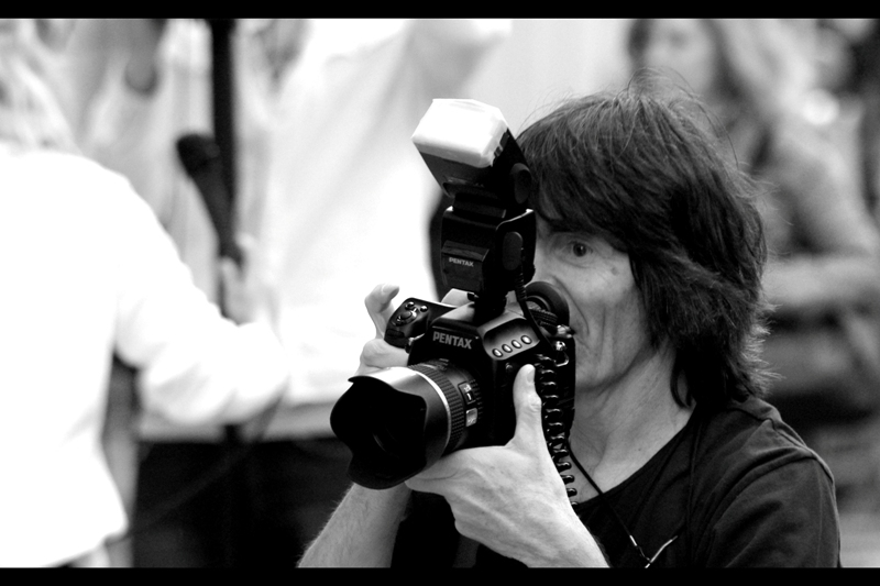 The man on the red carpet with the Sitting Down method of taking photos? Shoots PENTAX. And not just Pentax (because I shoot Pentax... it's totally a legitimte brand) but rather Pentax Medium Format Digital. Which is not only enough to put a whole lot of DSLRs to shame in terms of 40 megapixels on a giant sensor (at 1 frame per 1.1 seconds), but is like bringing a hand grenade to a game of scissors-paper-rock. .... Albeit a very _slow_ hand grenade....