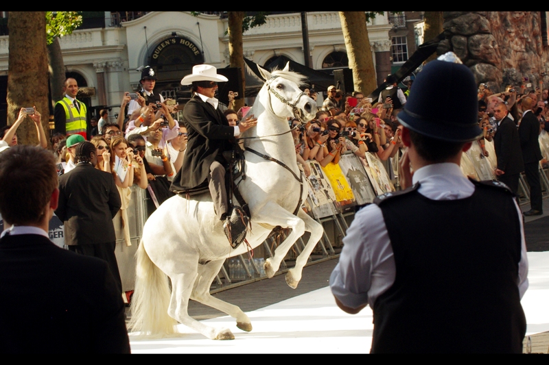 I'd spent mere hours standing next to some noisily excitable Turkish guys who were surely far too young and far too MALE to truly be plausible fans of Johnny Depp, and who were folding and tearing and rolling large The Lone Ranger posters into smaller pieces. And while I pondered "why?", a man on a horse arrived.