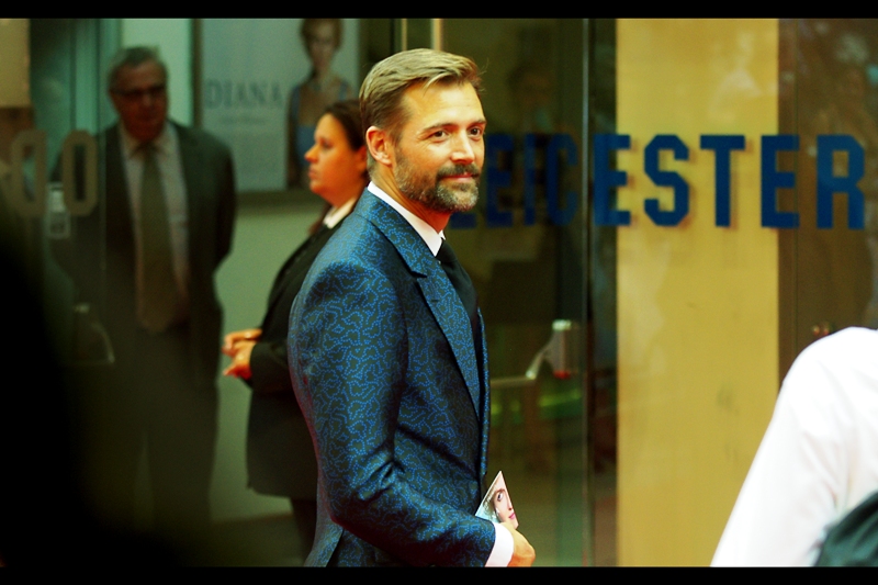 I have no idea who this is, but the suit jacket is exquisite. It's like they covered individual silkworms with highlighter pens and got them drunk and hypnotised them.