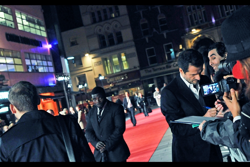 The former (yet eternal) Yellow Cap Guy (far right, grinning at David Hayman) has returned from his retirement to grace Leicester Square for the second time in two days. He seems to have softened a bit - I guess retirement will do that.