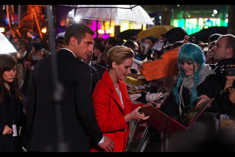 Jennifer Lawrence signs autographs, and possibly proofreads implausible Hunger Games fanfiction.
