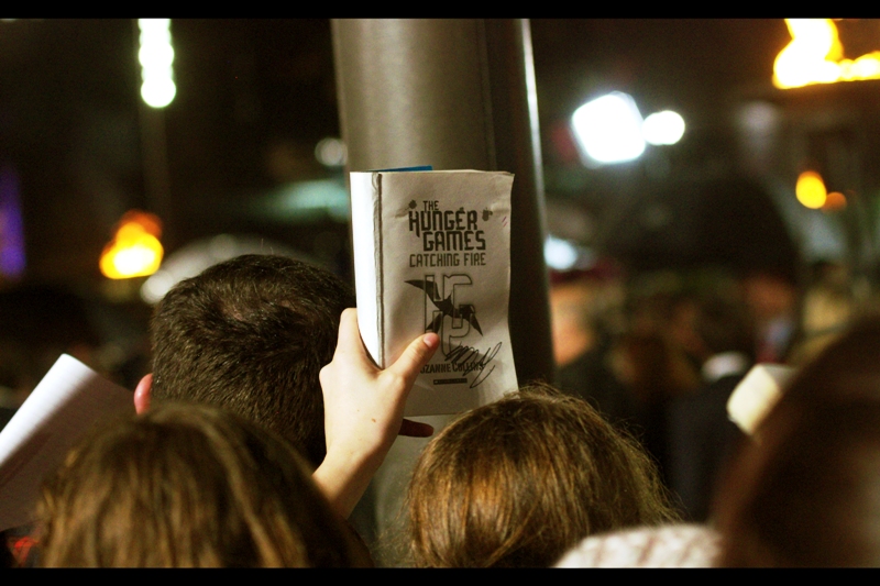 "Security! Some old dude in a suit scrawled over all over my nice new Hunger Games Book. I think he was the director..."