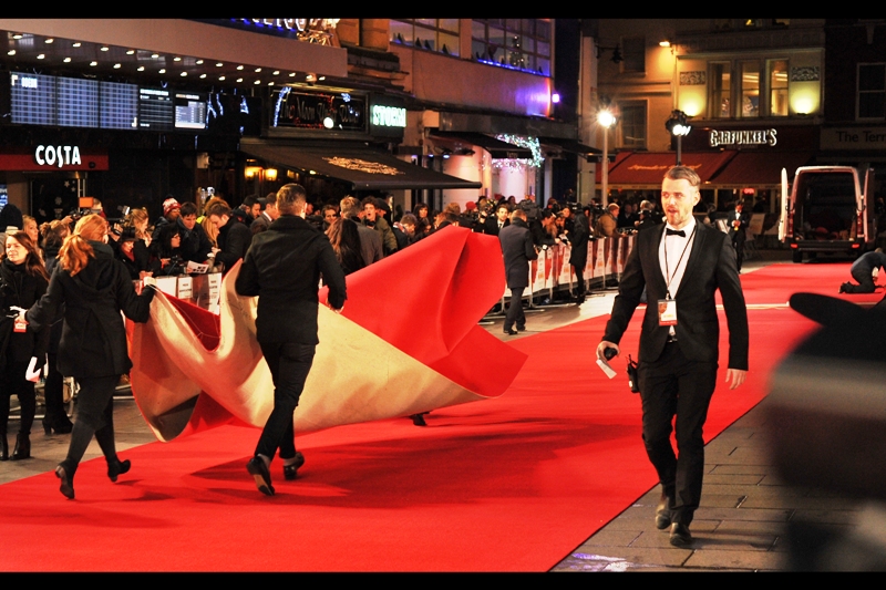 It's finally getting close to starting - so close that security and organisers are running surplus fabric to the waiting truck to clear the Red Carpet so that the experts can make last minute carpet adjustments and proceedings can begin.