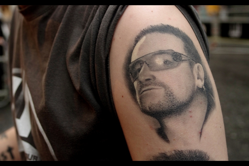 The Spanish couple standing next to me (and who sheltered under my umbrella during what we're calling "Torrential Downpour 2011") were big U2 fans. How big? The guy had tattoos of Bono and Larry Mullen Jnr on his left arm.