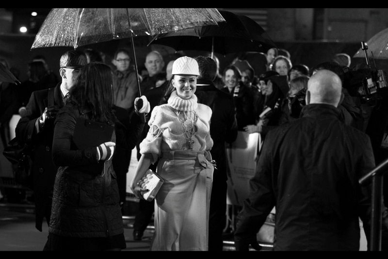 I have no idea who this is, but the dress looks ludicrous enough and Colin Firth is completely surrounded by umbrellas off to the side, so what else am I going to photograph right now?