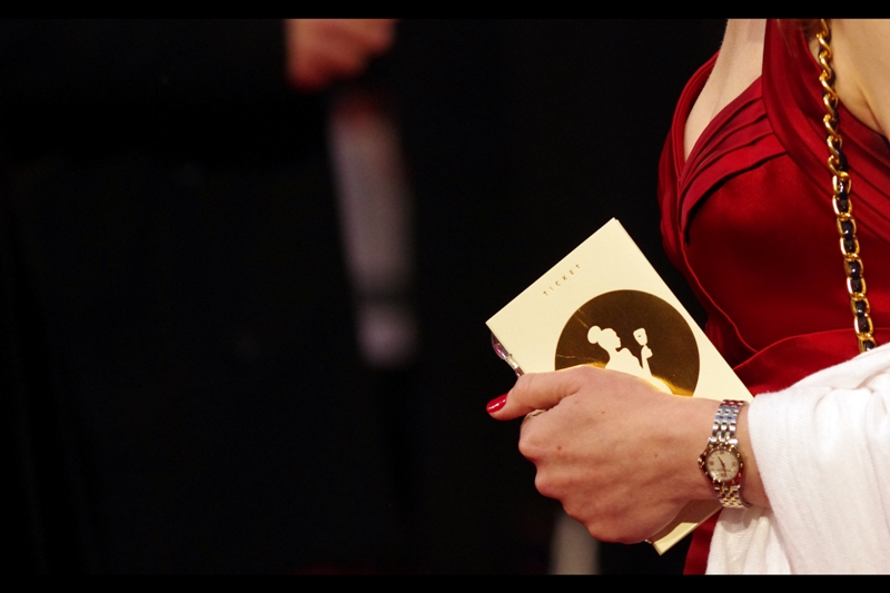 This is what a Bafta Ticket looks like. Based on the attire of the person clutching it, she probably didn't queue and wait for a total of upwards of 10 hours (or have a combination of Chinese and Puerto Rican tourists shoving her)