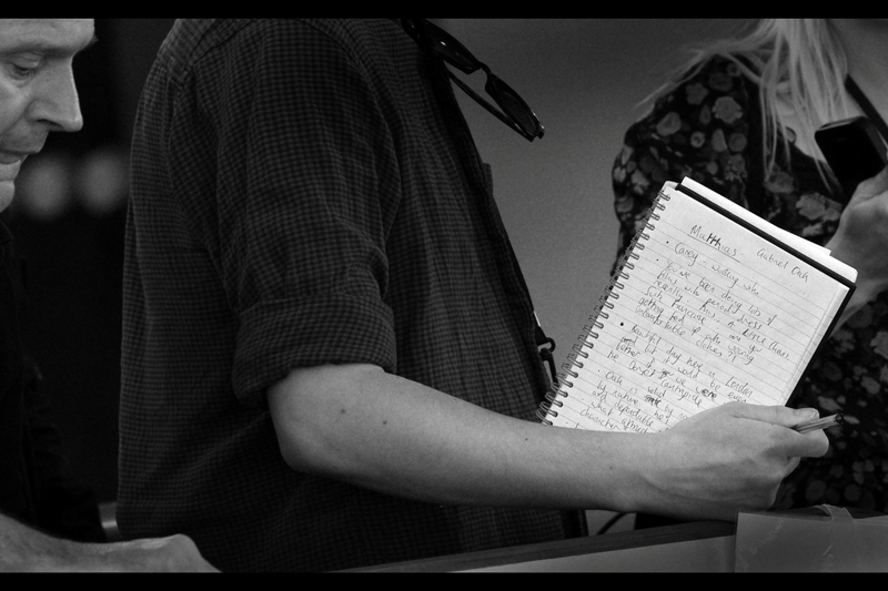Behind-the-scenes shot : somebody has written out questions to ask actor Matthias Shoenaerts. The questions are written on paper, kids : that's like an iPod but individual pages are made of tree pulp products and are both disposable and recyclable.