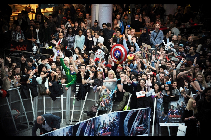 "Yes... those are MY tickets to the premiere screening! Please pass them over" Spirits remain high among the people with wristband access, though sadly many of them are as yet unaware that the empty space in front of them is being kept clear for four rows of Paparazzi to occupy later.