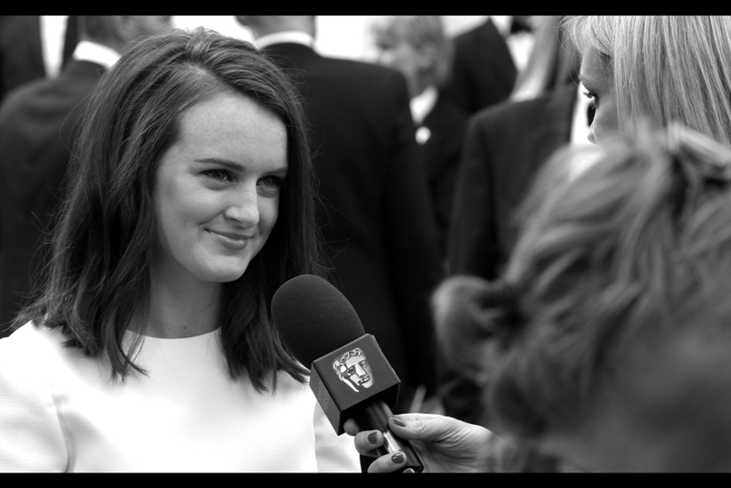 I don't know who's being interviewed, but I can recognise Baffy the Baftas Head Logo. I'm a big fan of his work, and the askew microphone head he's attached to. (Edited to add : Sophie McShera)