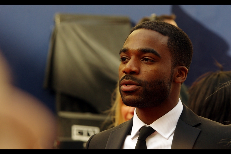I don't know who he is, but when I buy new shoes they're not as shiny as his suit. I should buy better shoes... (edited to add : Ore Oduba?)