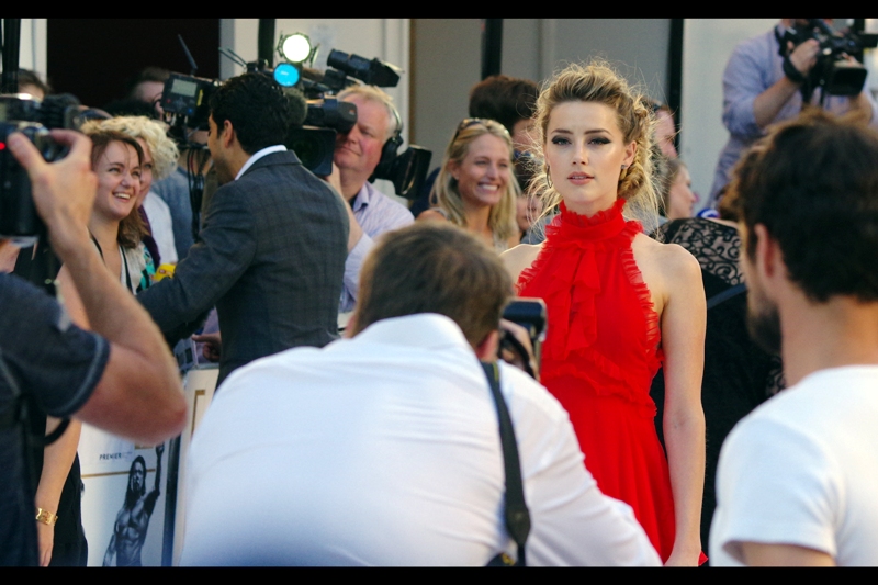 Amber Heard's gaze passes beyond the VIP Paparazi cordon and finds my camera. My reflexes are fast enough to take the photo, but not fast enough to put down the camera and make *actual* eye-contact. Being a photographer is sometimes all about horrific sacrifices. (although fortunately I have the photo to remind myself of that sacrifice).