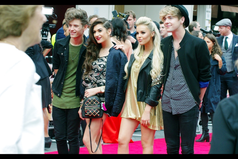 I don't know who these people are, but I'm given to understand they're... some kind of pop group, reality show crew, or fashion label representatives. Mightily important to the youth of this great country, I'm sure. Young, pretty, successful. Oh, how I hate them...