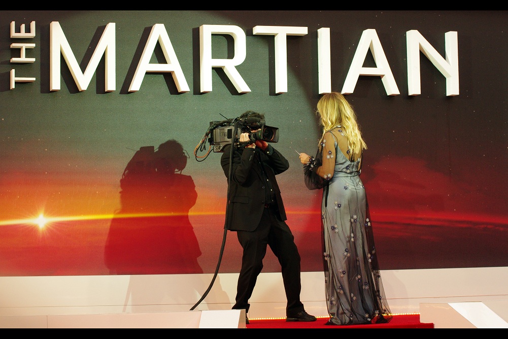 "Hello, world! Tonight we're coming to you live from... well... the same planet we're all on. It really sucks that NASA's budget keeps getting cut in preference to maintaining the USA's military industrial complex... or prisons or whatever they're spending their money on. In other news... there's a premiere on!!"