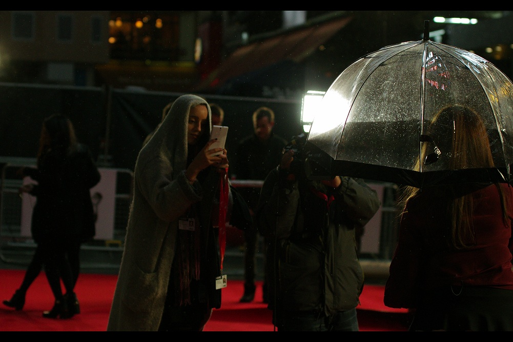 .. .and then it started to rain, making things even MORE serious and real. (And I think this lady is using a Samsung phone at an event celebrating the founder of Apple.... so it's possibly getting Seriously and DANGEROUSLY real.)