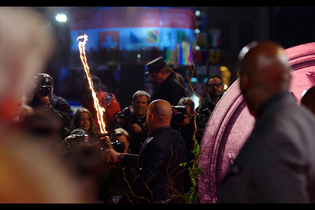 Vin Diesel has arrived, to the screams of far too many Spanish ladies over the age of 40 in the crowd to really make sense, given this is London. In separate (and possibly not related news), and to the panicked Chagrin of his personal assistant and/or personal insurance company, Vin immediately grabbed That Guy's flaming sword and started waving it around.
