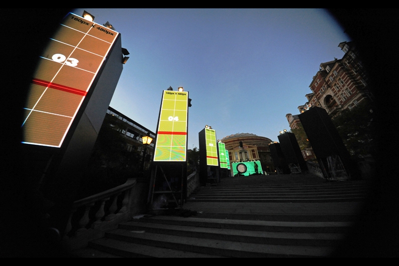 T-minus 26 hours. The statue in front of the Royal Albert Hall has been obscured by a large screen and a stage with two black amorphous shapes on it. Mysterious...