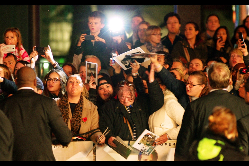 Bradley Cooper heads to sign in the far reaches, and it's a near-riot in the autograph dealer/ hunter/ collector/ mercenary pen. I now look at this photo and mostly see small kids perched on the shoulders of indulgent parents, or possibly confused total strangers.