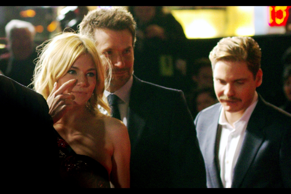 "Everyone keeps talking about how excellent the low-light capabilities of modern cameras is... so why am I still being blinded by press photographers and their damn flashes at every premiere??" Sienna Miller, Bradley Cooper and Daniel Bruhl grab a brief respite from the onslaught.
