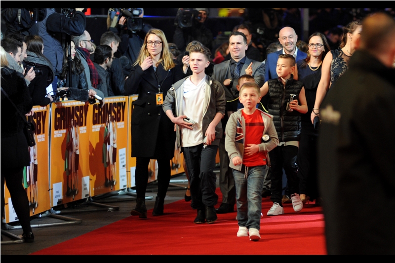 Norman "Nobby" Grimsby's kids walk the red carpet with a mixture of insouciance, profanity, and confusion as to where the women in swimsuits came from or went to.