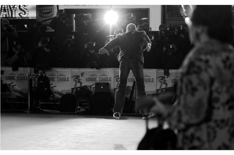 Big thanks to leopard-print lady for walking into this shot of Eddie the Eagle jumping (also, big thanks to passing security dude who blocked a second jump) (also, big thanks to OTHER passerby blocking a third jump) (and big thanks to a rare autofocus fail from the Nikon for failing me on a FOURTH jump). Sigh. Some days you just want to blame all people who wear leopard-print to a premiere, though....