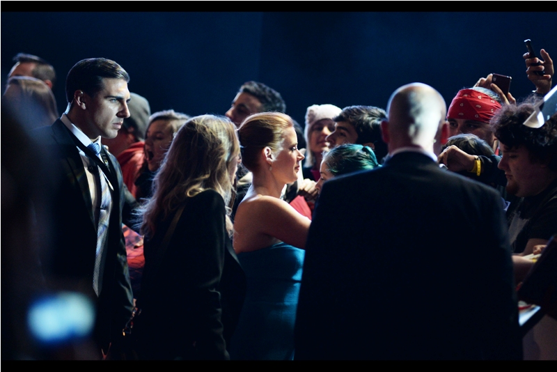 Meanwhile, there's a lot to like in this photo : from the scarily intense look on the face of the security dude on the far left, to the person seeminly using a a 1999-era Nokia phone (which if memory serves didn't actually have a camera) on the far right.. and the lovely Amy Adams in the middle.