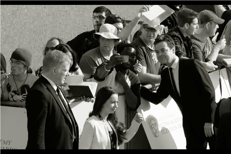 I don't know who this is, and disappointingly the floppy hat of the guy in the crowd near him is doing a better job of drawing my attention.