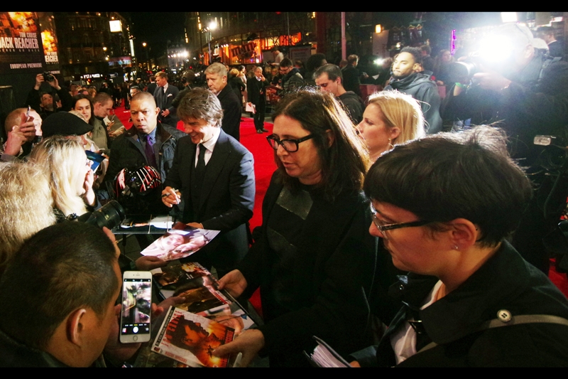 Tom Cruise's dual assistants rove ahead of their boss, asking people to prepare things to get signed (limit : 1 per person at this stage), and also hand over cameras so they can take a photo of you with Tom Cruise.